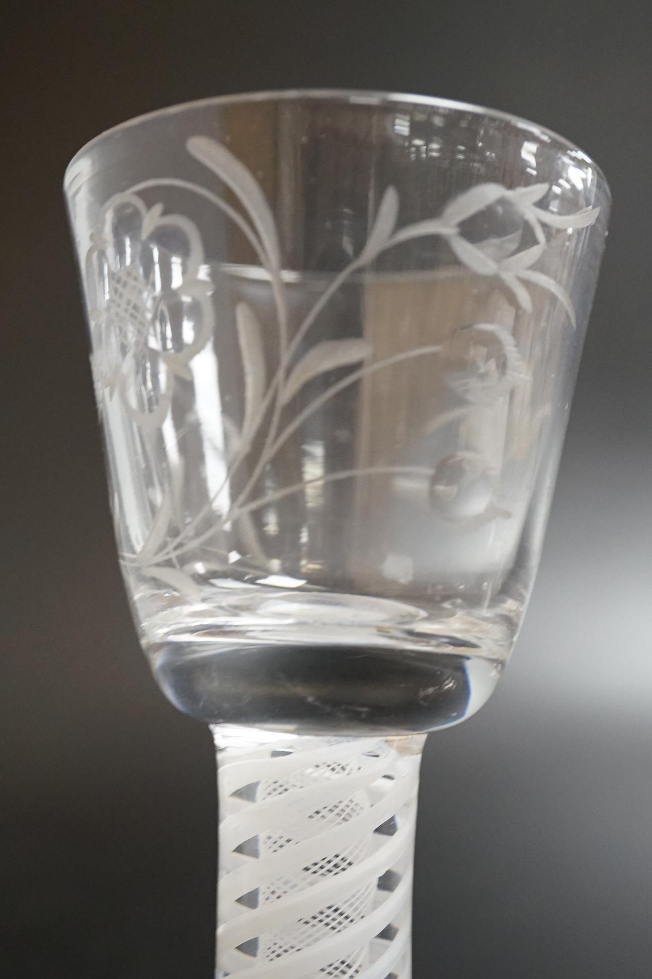 Two George III firing glasses, one with DSOT stem, together with a gin glass with engraved bowl, tallest 11.5cm high (3)
